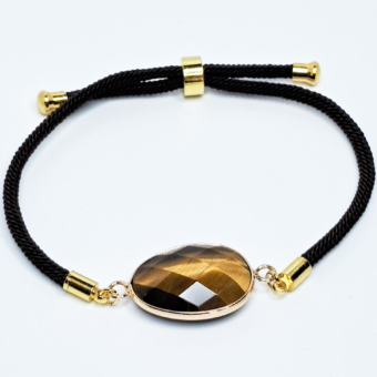 Bracelet œil-de-tigre, composé d'une seule pierre naturelle taillée, mesurant environ 2cm. Bracelet en cordon réglable noir.